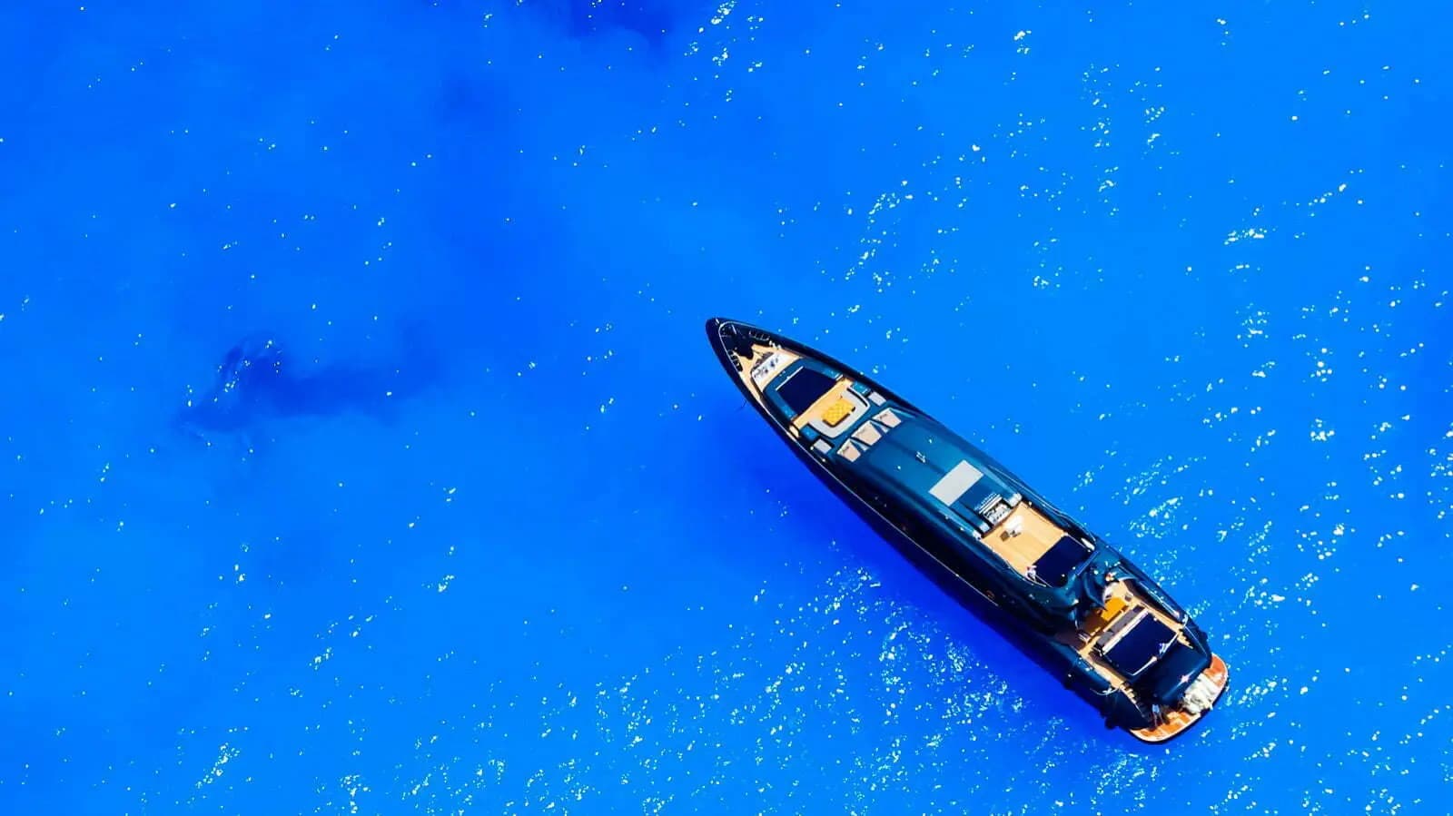 Aerial view of a motor yacht at anchor in deep blue water